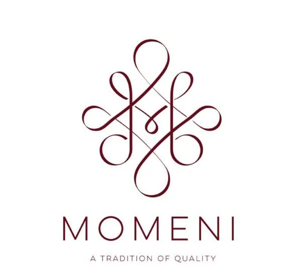 Elegant logo with intricate line art above the word "MOMENI" and the tagline "A TRADITION OF QUALITY".