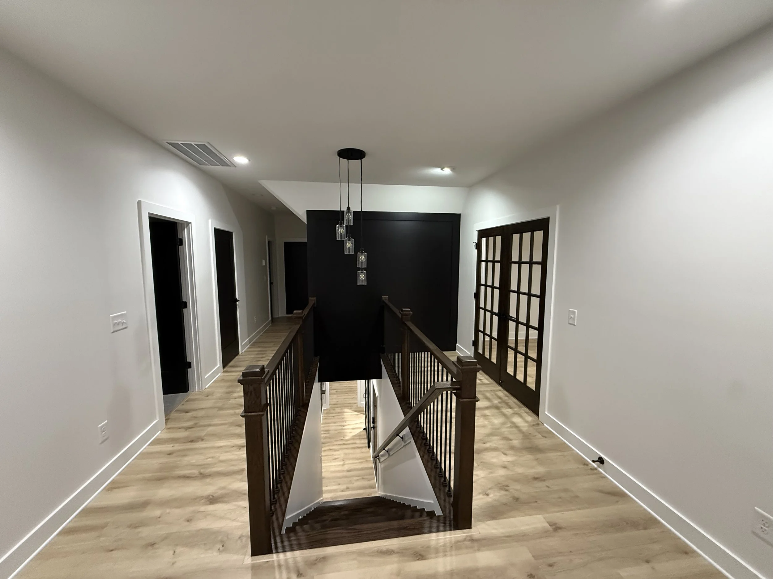 Custom farmhouse staircase with hardwood floors in Benson, North Carolina
