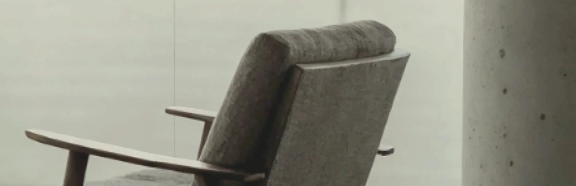 Mid-century chair in a quiet, light-filled room, suggesting space for a calm conversation.