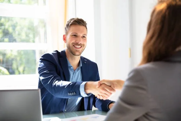 Man reaching out to shake someone’s hand