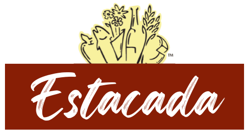 Logo with a cluster of vegetables in yellow at the top and the word "Estacada" in white cursive text on a red background.