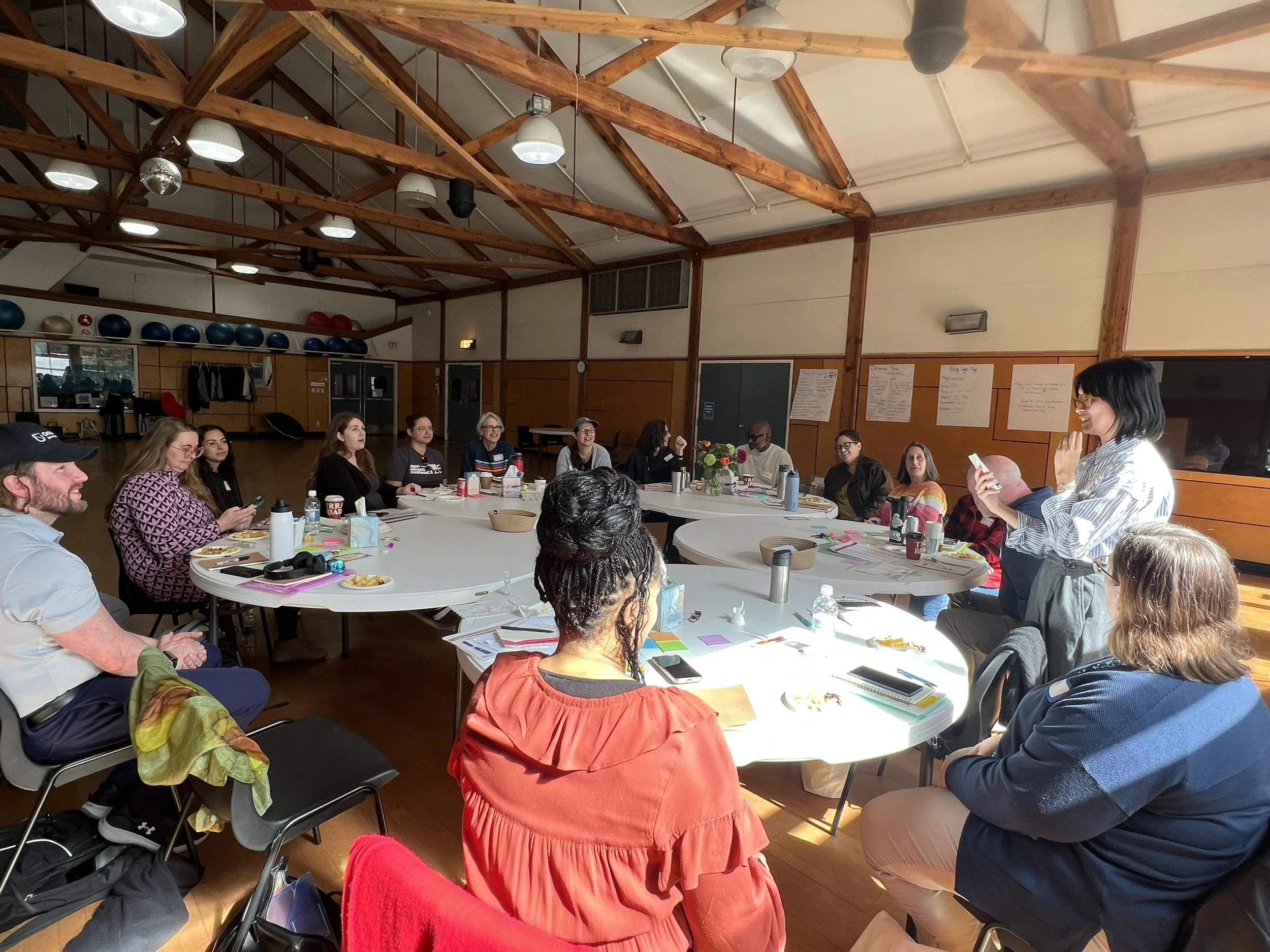 Luminary participant partake in conversation in-person