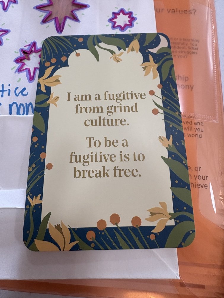 Card that reads "I am a fugitive from grind culture. To be a fugitive is to break free."
