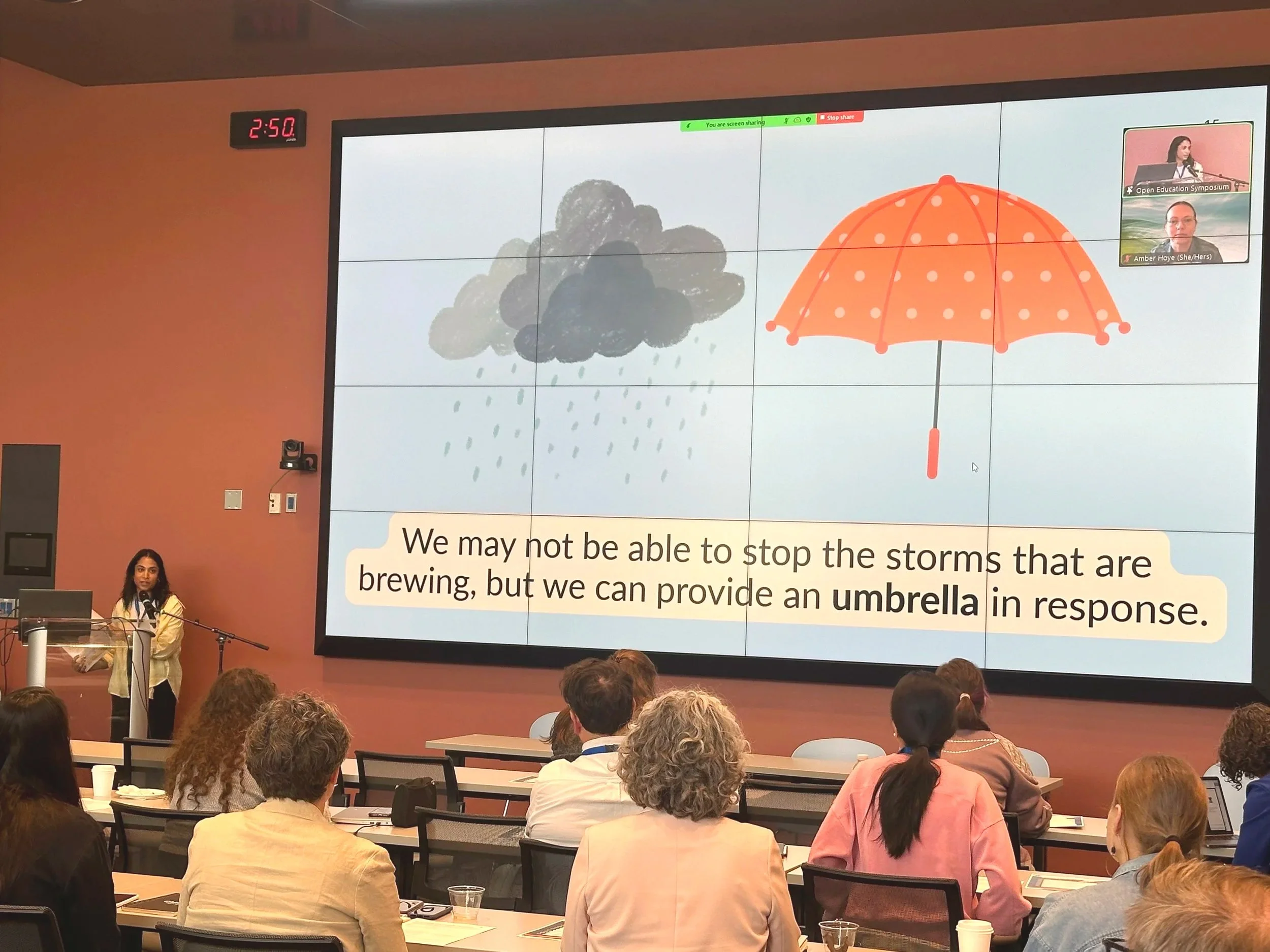 Presenting at Open Horizons Workshop. Slide has the quote "We may not be able to stop the storms that are brewing, but we can provide an umbrella in response."