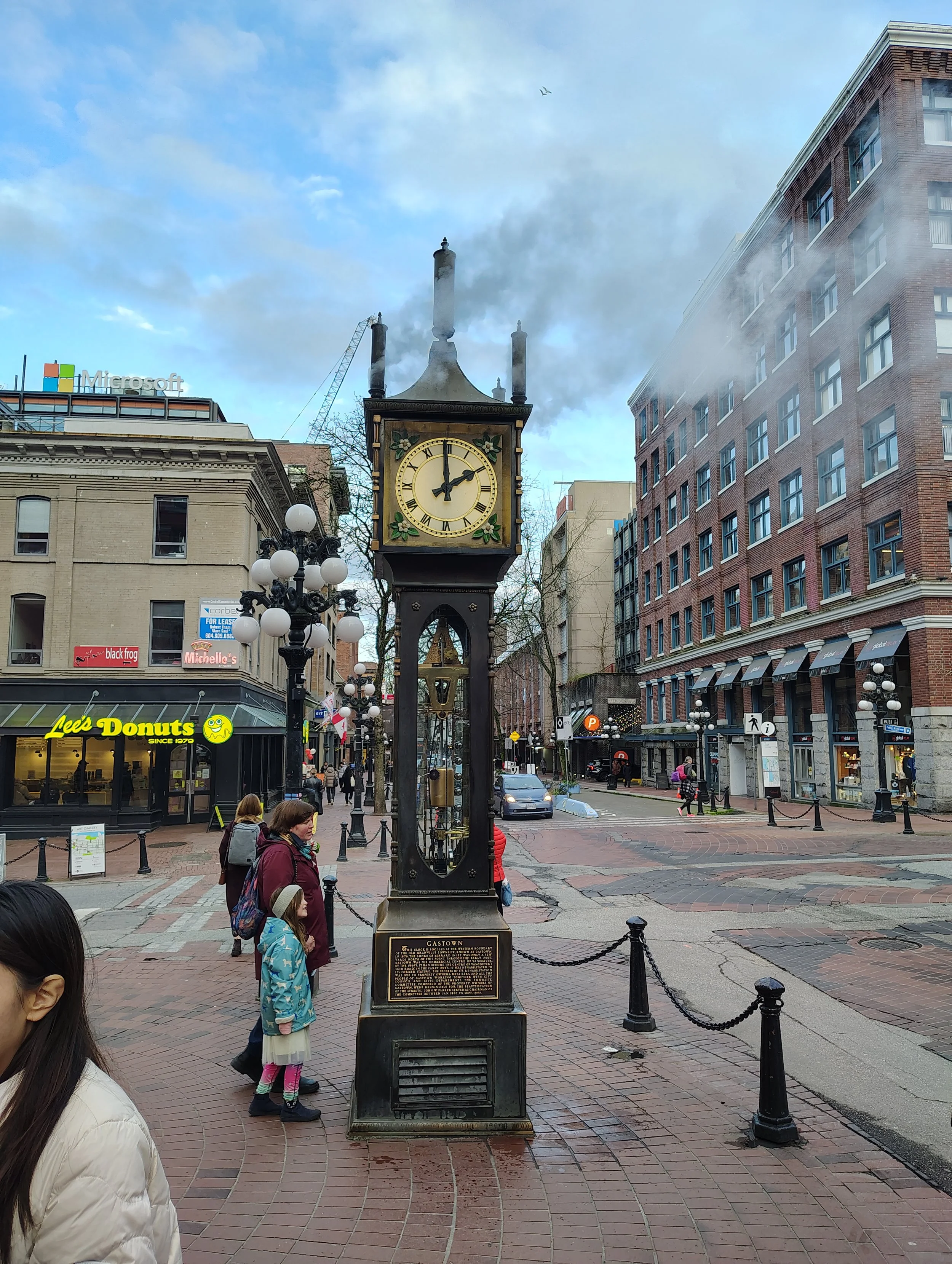 Gastown steam clock with steam pouring out overhead.