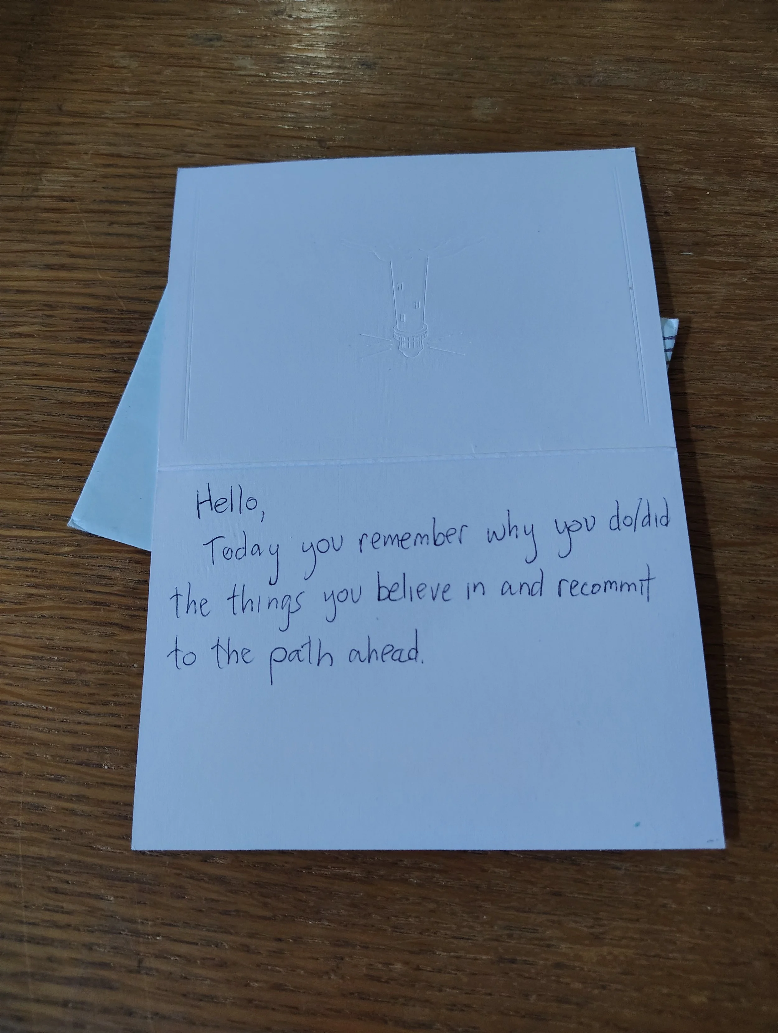 A message written in a card: "Hello, Today you remember why you do/did the things you believe in and recommit to the path ahead."
