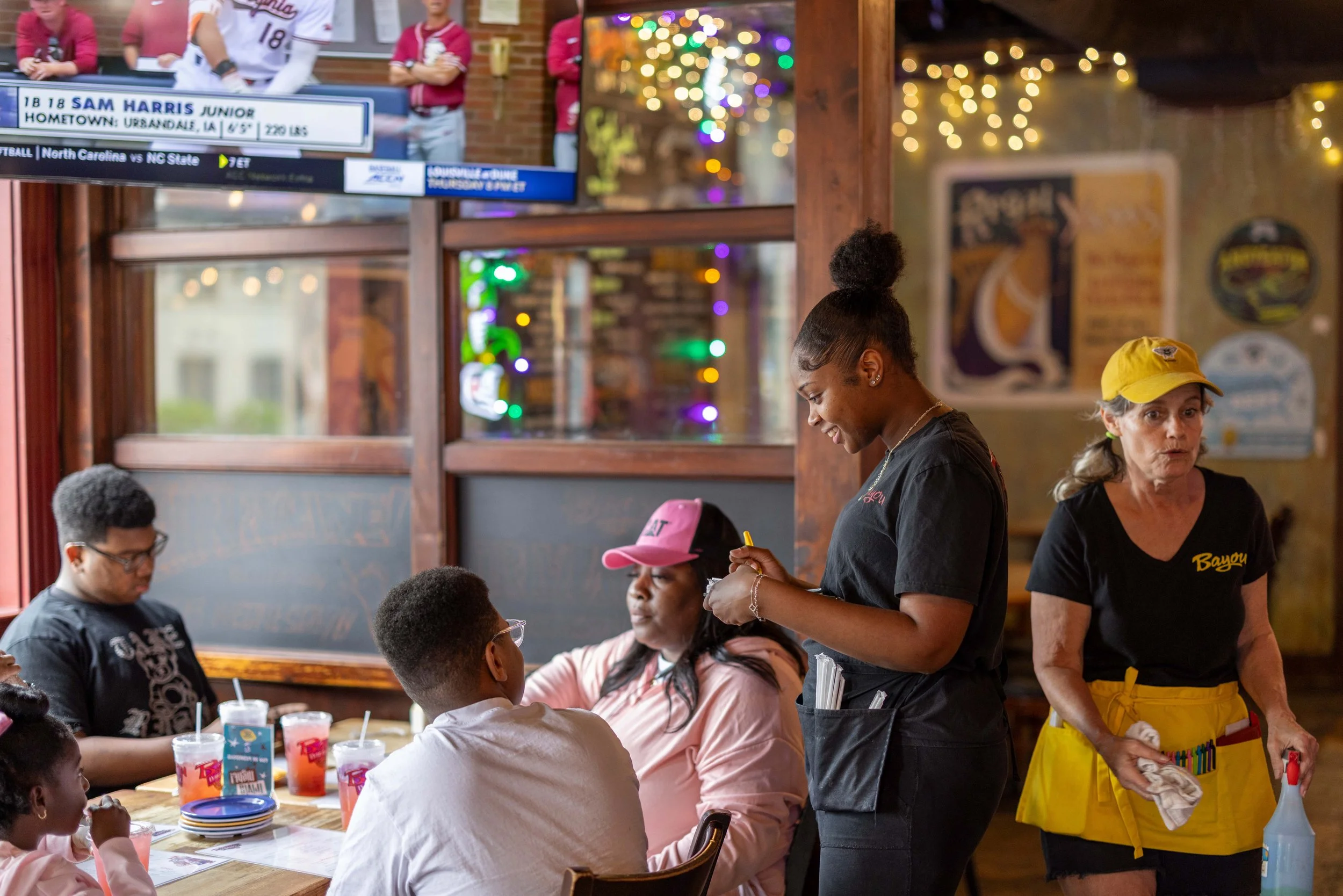 Server at a table talking to guests.