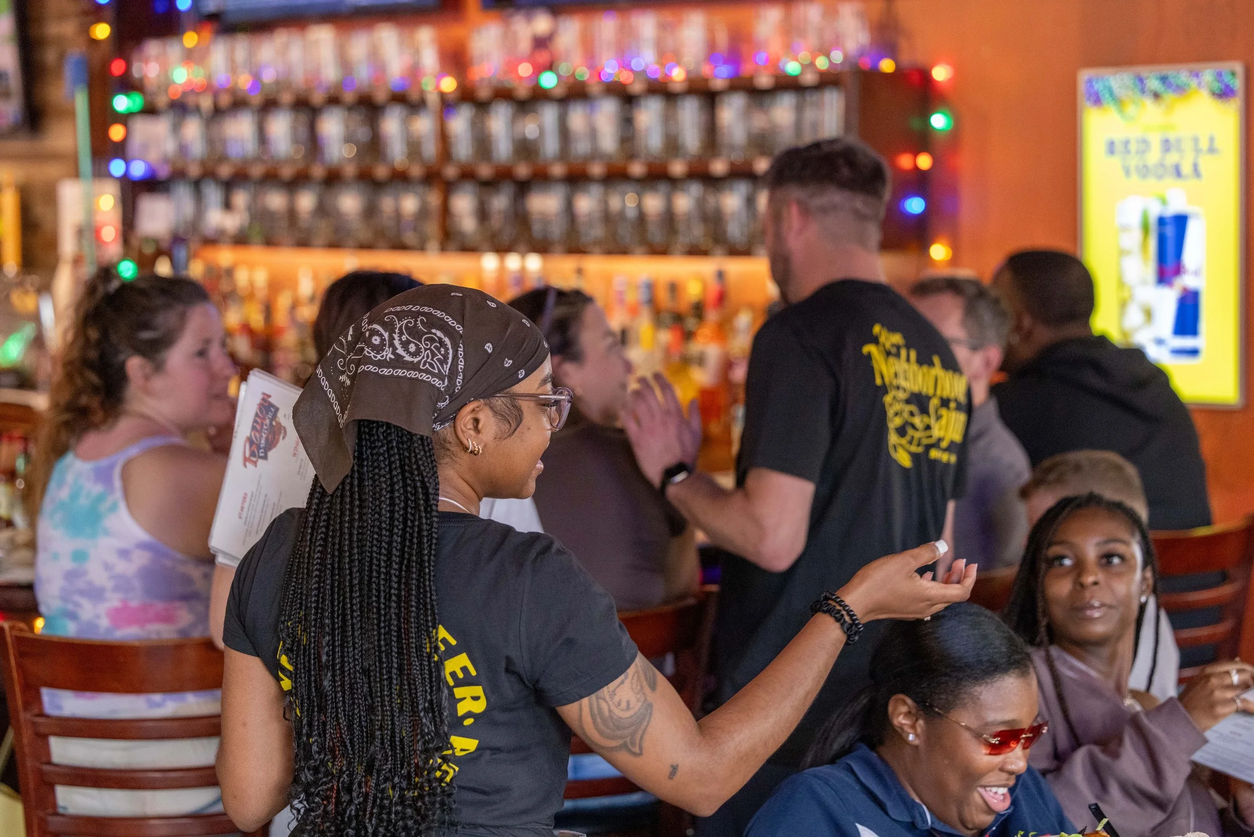 Server interacting with customers at their table.