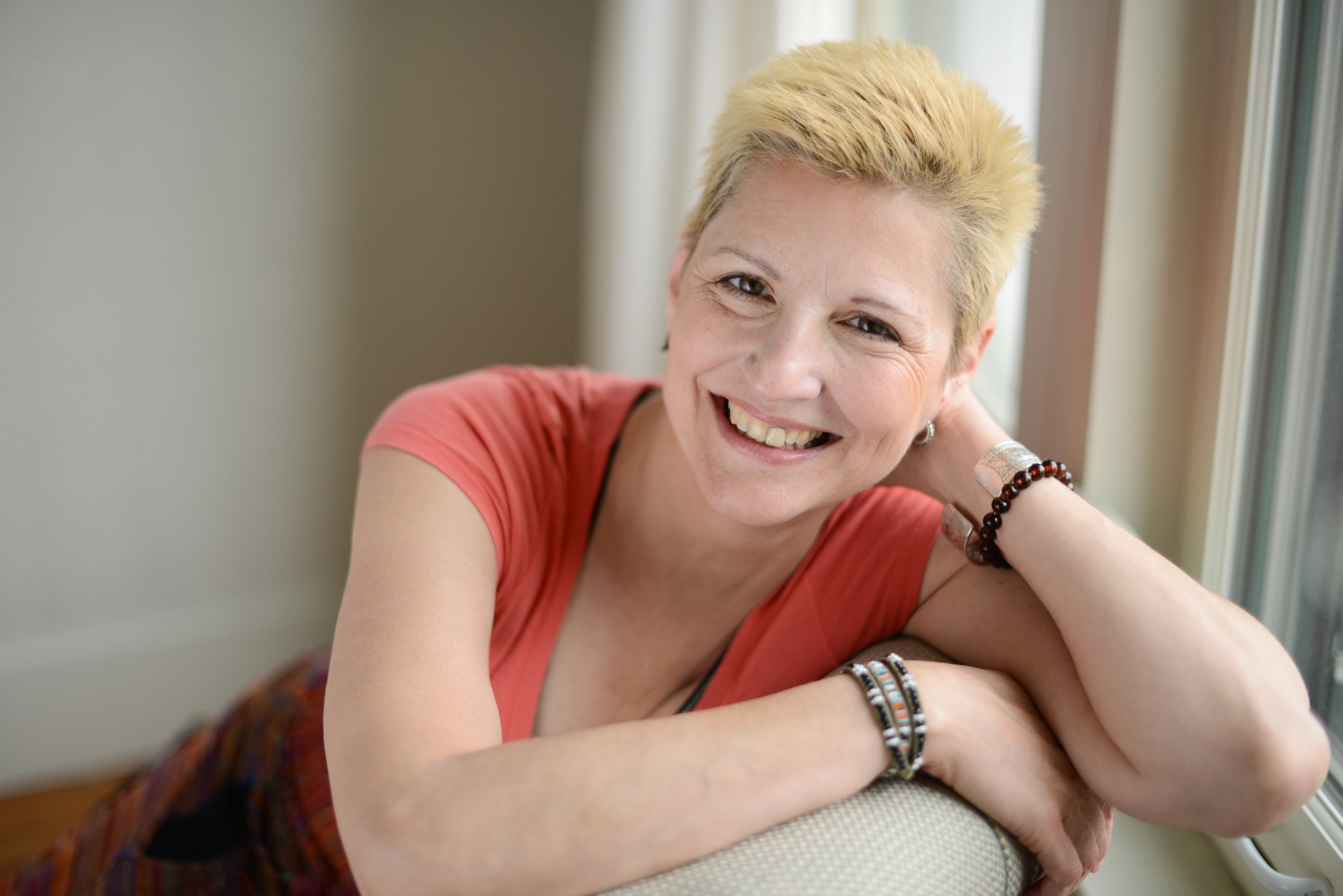 head and shoulders picture of Ruth Anne Lundeberg, A middle age woman with short blond hair, seated, looking into the camera and smiling