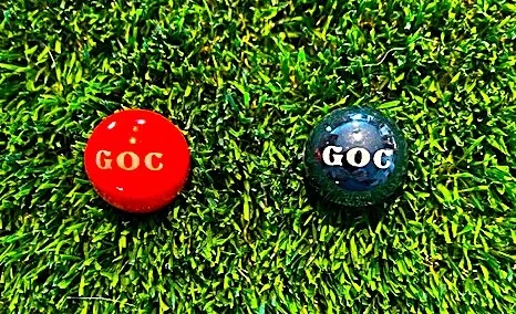 Red and black marbles with GOC written on them.