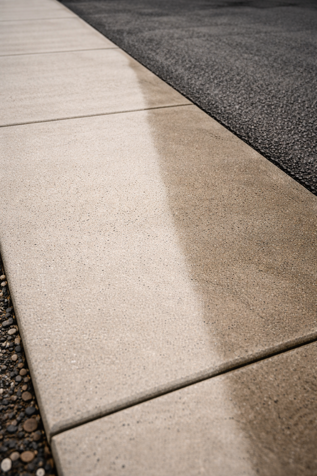 Concrete sidewalk slabs with powerwashed finish at a commercial property.