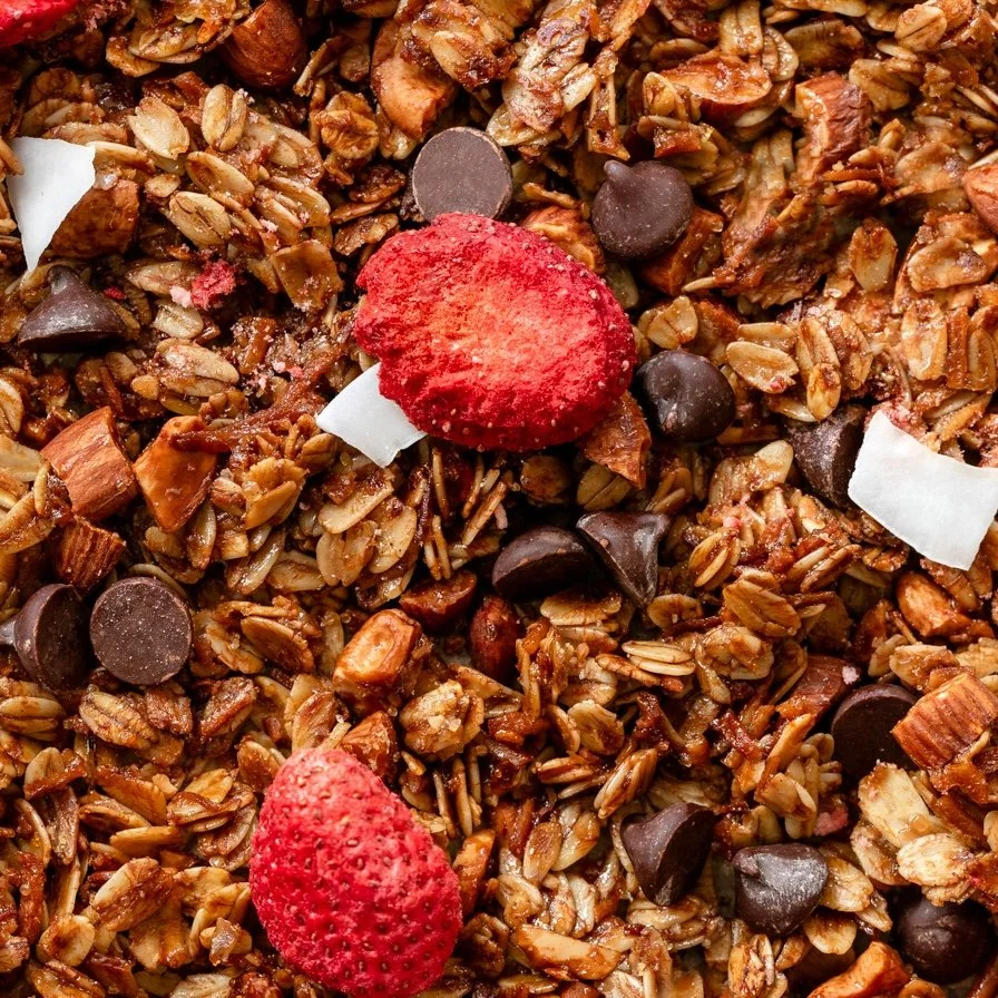 Close-up of granola with dried strawberries and chocolate chips.