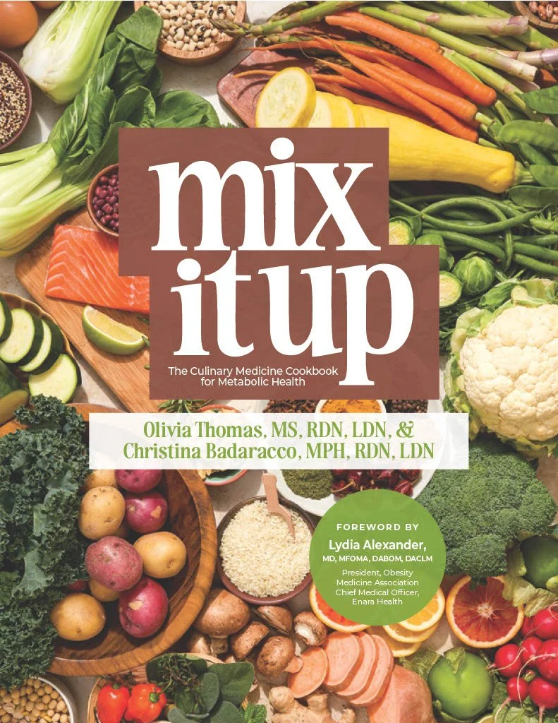 Book cover titled "Mix It Up: The Culinary Medicine Cookbook for Metabolic Health" featuring an array of fresh vegetables, fruits, grains, and seafood.
