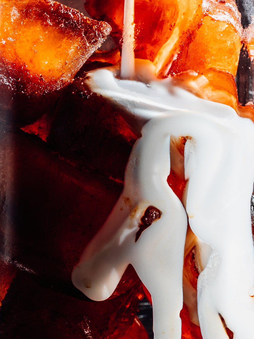 Close-up of roasted vegetables covered with white sauce.