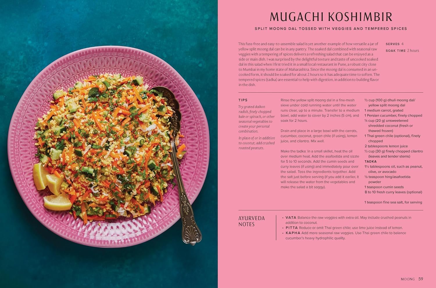 A pink plate with a colorful mixed vegetable salad on a teal surface, with a silver fork resting on the edge of the plate. The salad contains finely chopped vegetables, herbs, and lemon wedges.