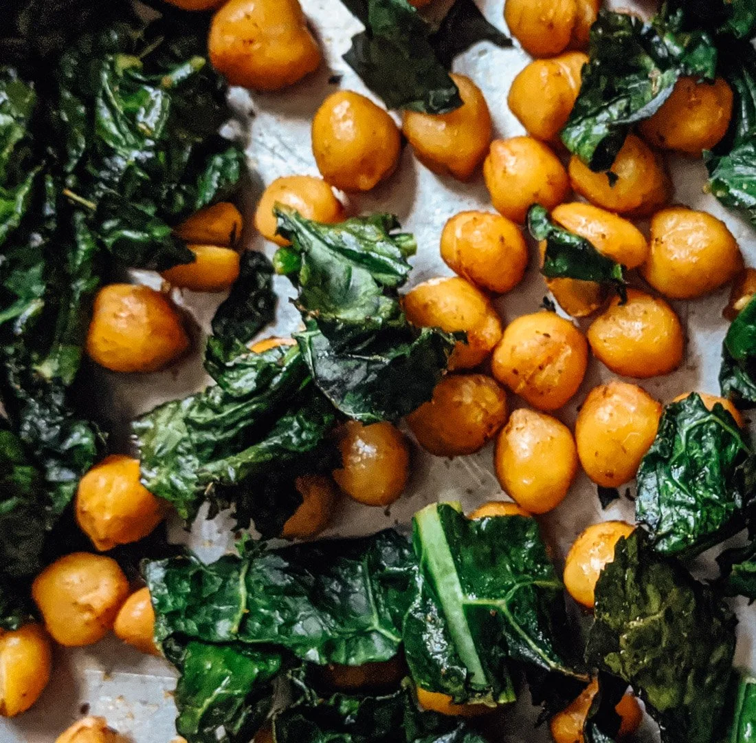 Roasted chickpeas with roasted kale on parchment paper