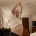 Person lifting shirt to expose stomach in a room with beige walls and furniture