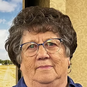 Older woman with glasses smiling