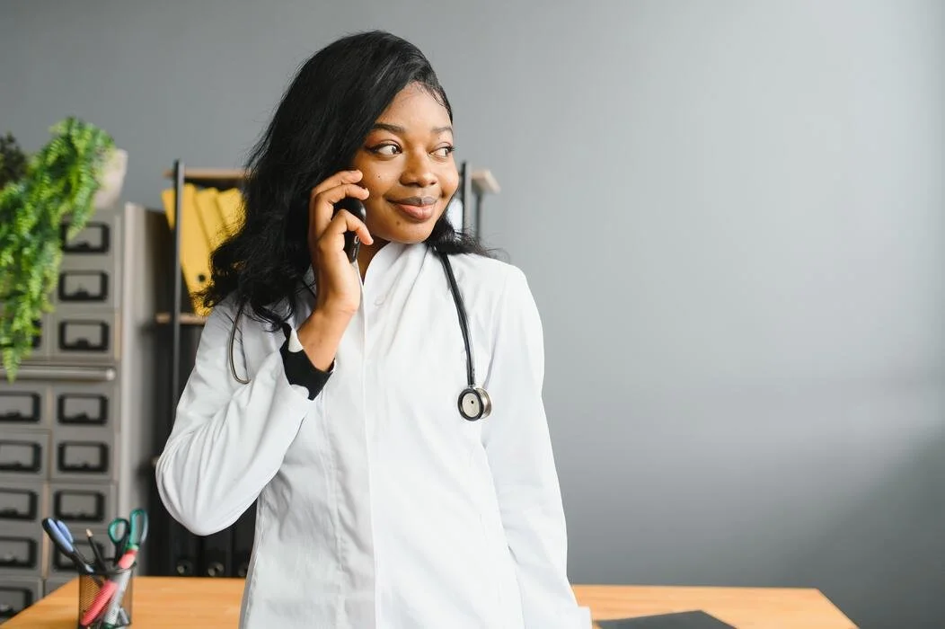 A Nurse answering a phone call from a client