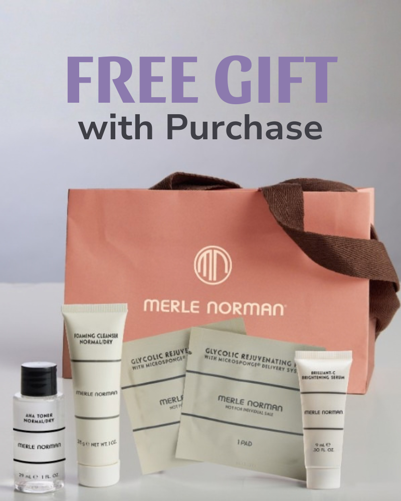 Merle Norman skincare gift set displayed in front of a Merle Norman shopping bag with text reading “Free Gift with Purchase.”