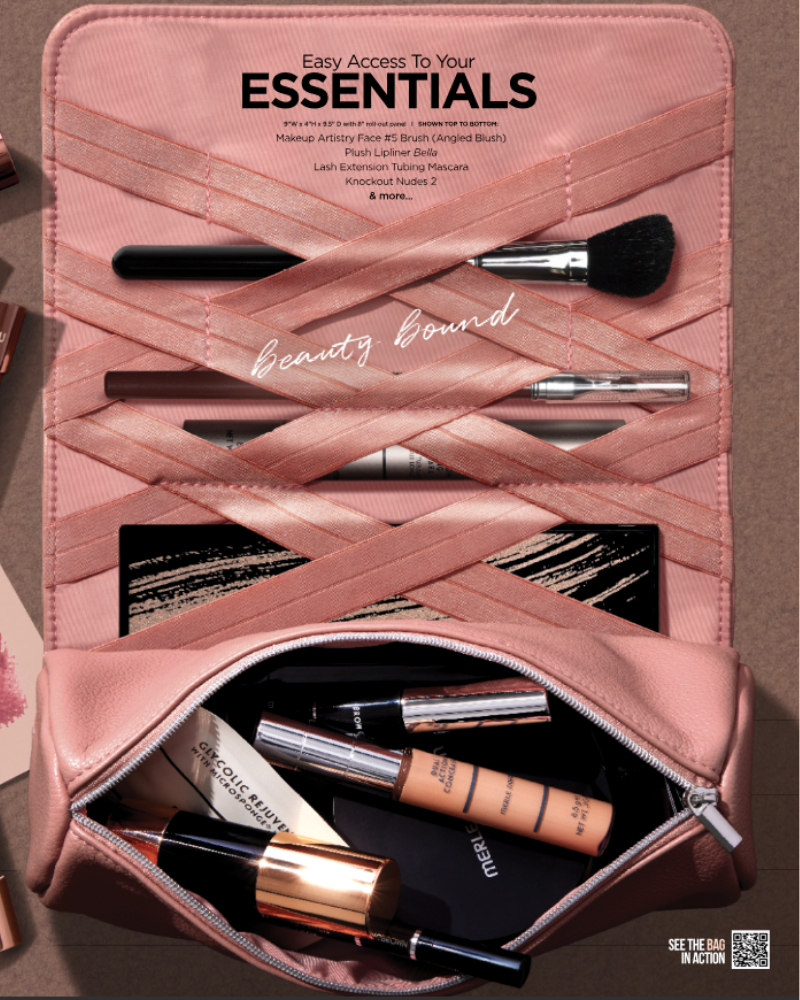 Pink Merle Norman Beauty Roll-Up Makeup Bag with brushes, cosmetics, and everyday beauty essentials.