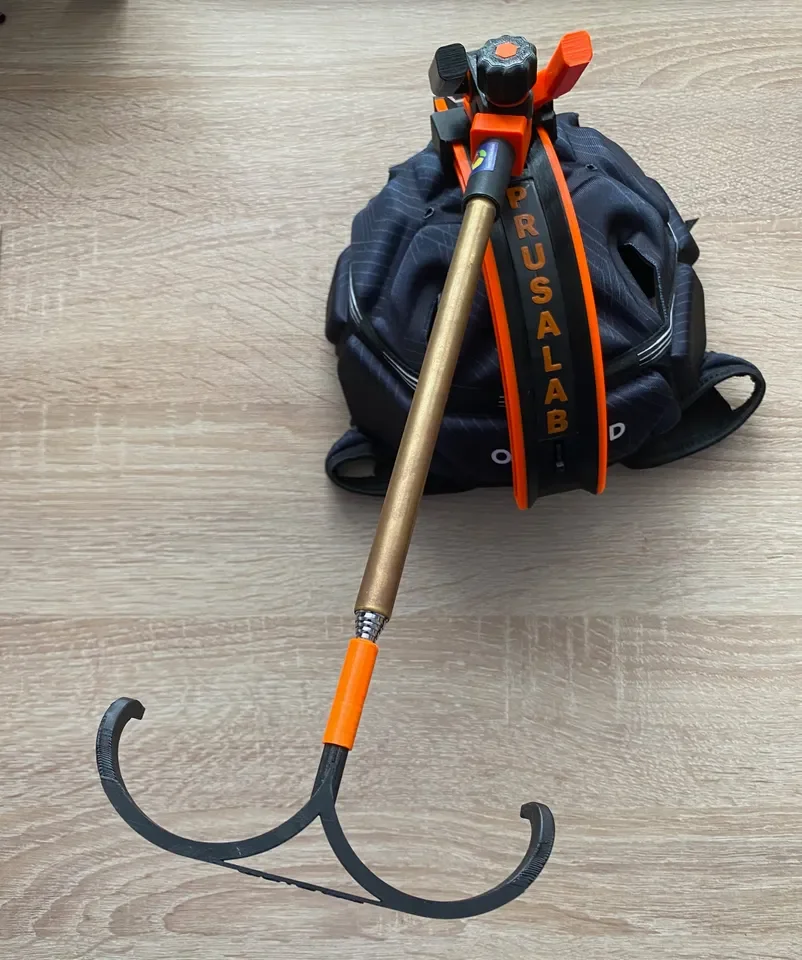 Firefighter Halligan tool, axe, and breathing apparatus on wooden floor.