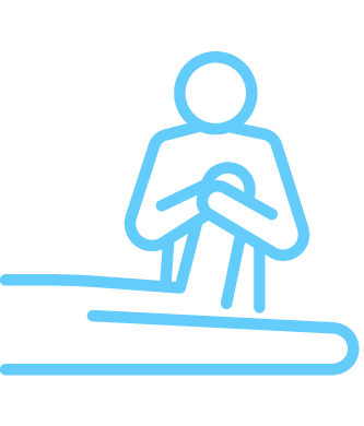 Line drawing of a person holding a baby, standing behind a table.