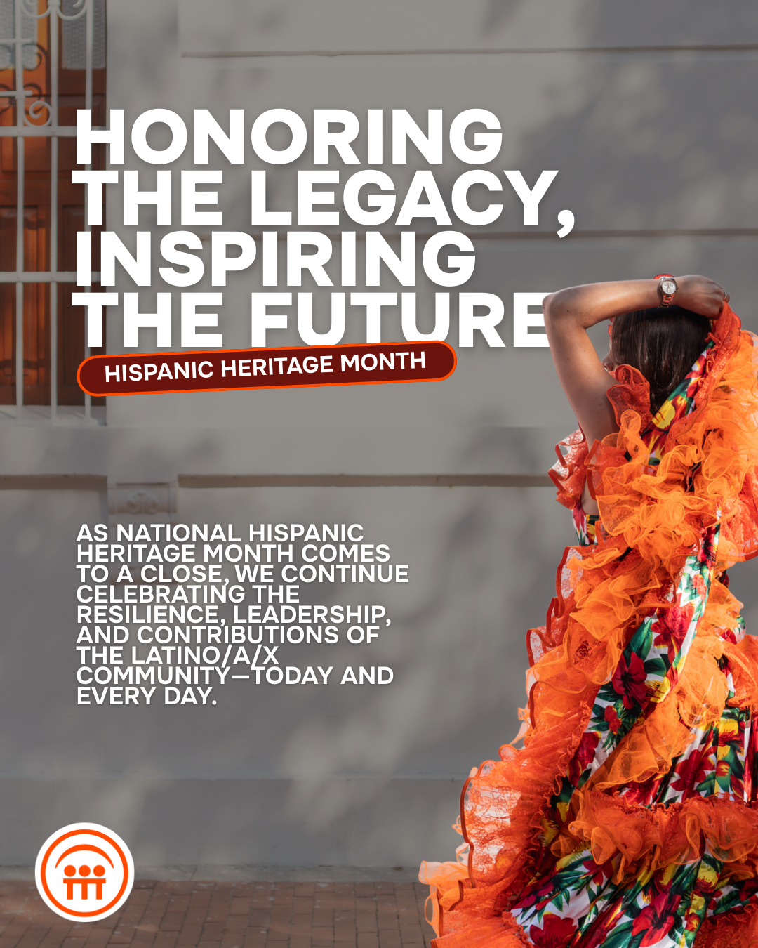 Woman in colorful traditional dress with orange ruffles, celebrating Hispanic Heritage Month outside.