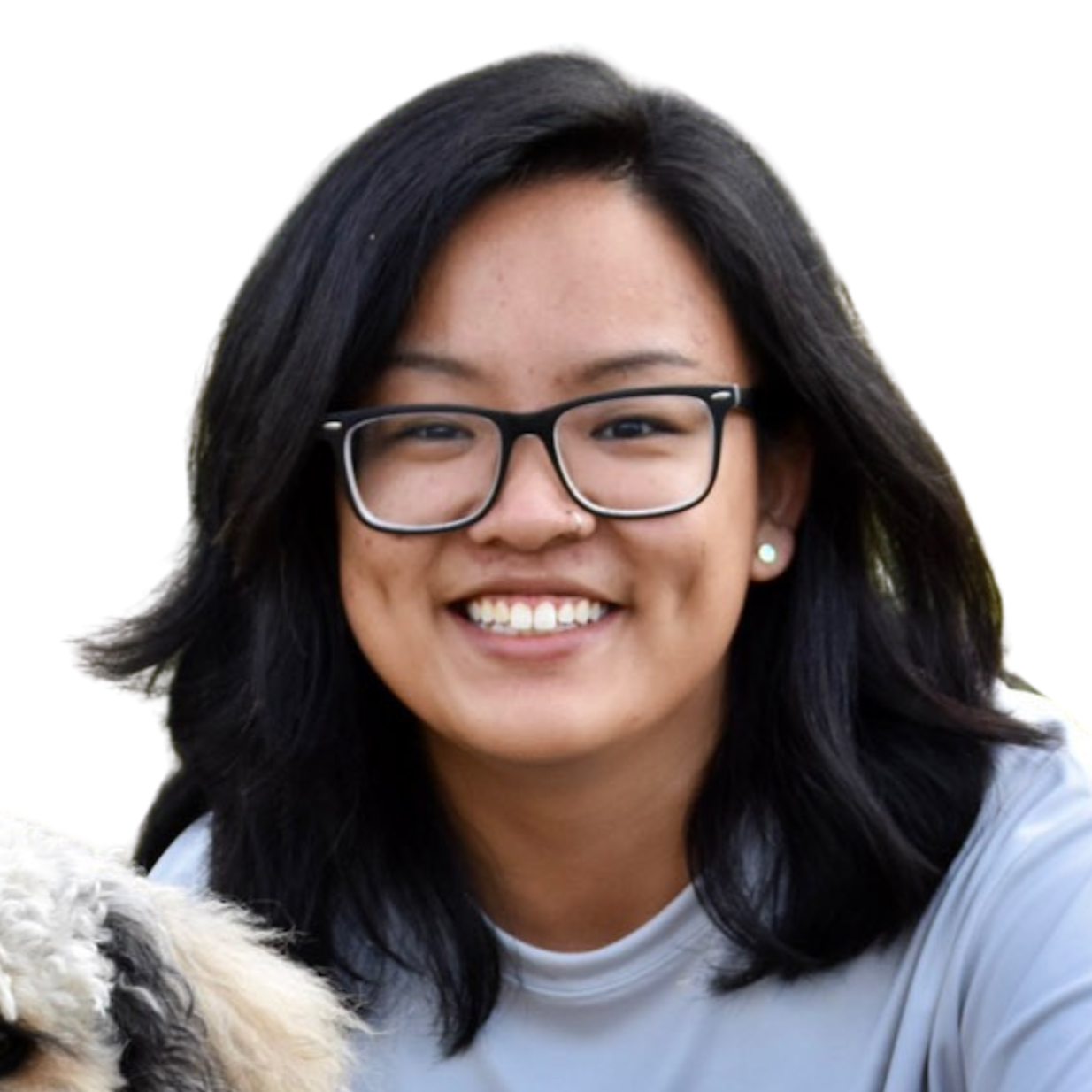 A young Chinese woman with shoulder-length wavy black hair, thick-framed black glasses, and earrings smiles at the camera in front of a white background.