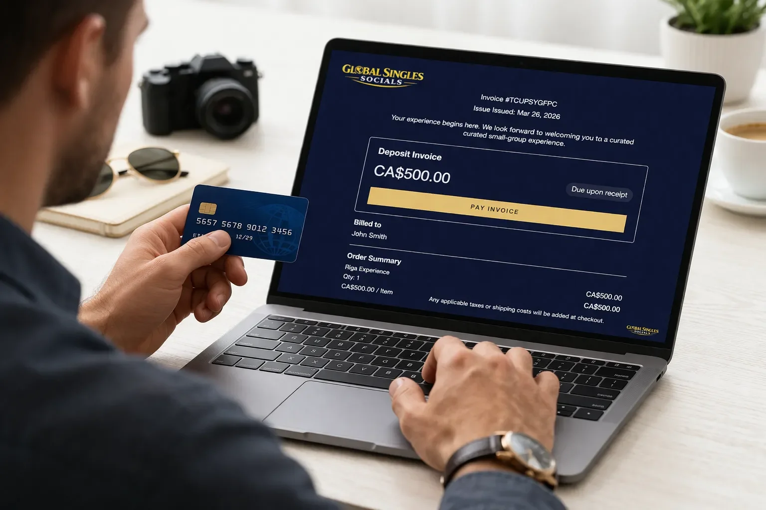 Man making an online payment for a Global Singles Socials travel experience deposit on a laptop, holding a credit card in a modern workspace.