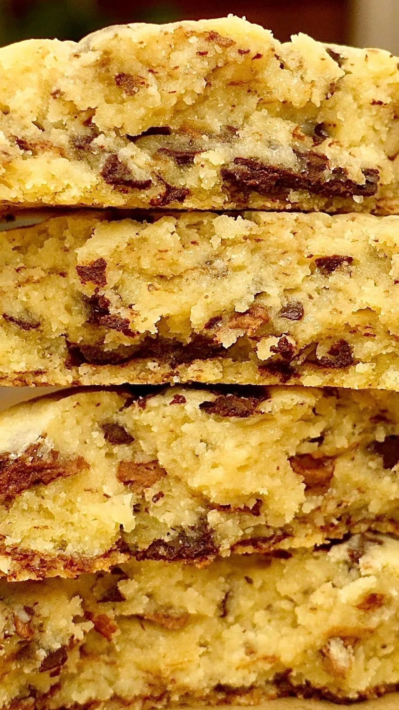 Close-up of stacked chocolate chip cookies showing their texture and chocolate chunks.