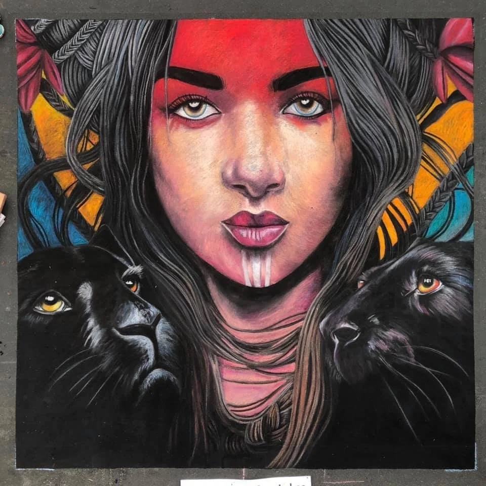 A colorful painting of a woman's face with two black panthers, background with vibrant patterns.