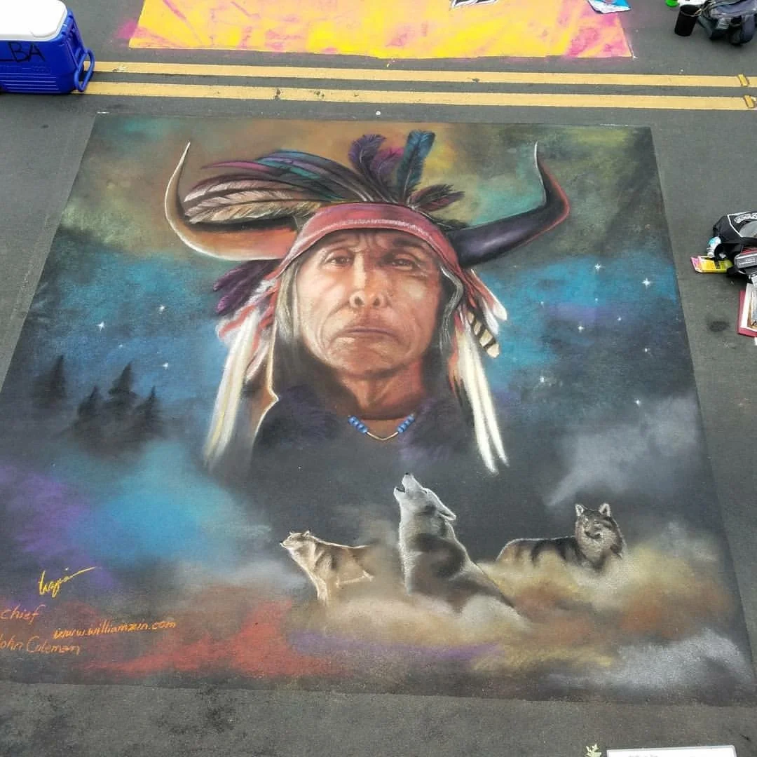 Chalk art depicting a Native American chief wearing a feather headdress with a serious expression, surrounded by three wolves and a colorful starry sky background.