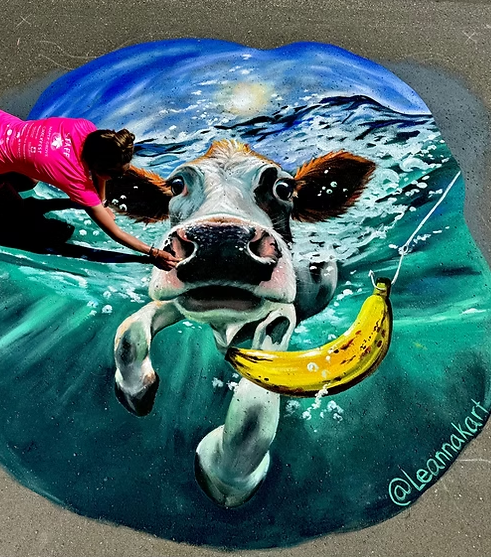 Chalk street art of a cow swimming underwater with a banana - Maple Grove Chalkfest
