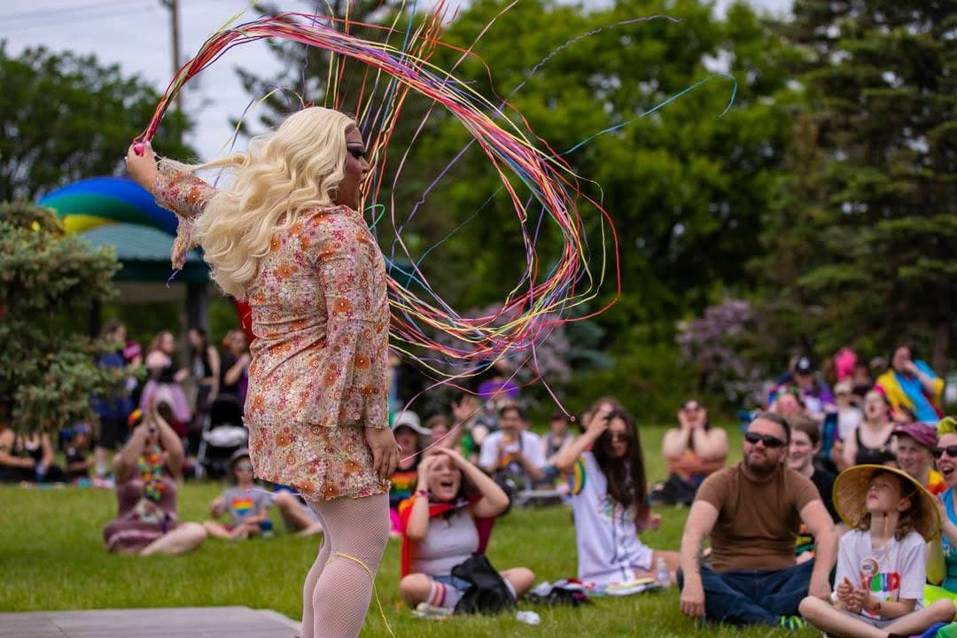 Mx. Dione throwing streamers while performing