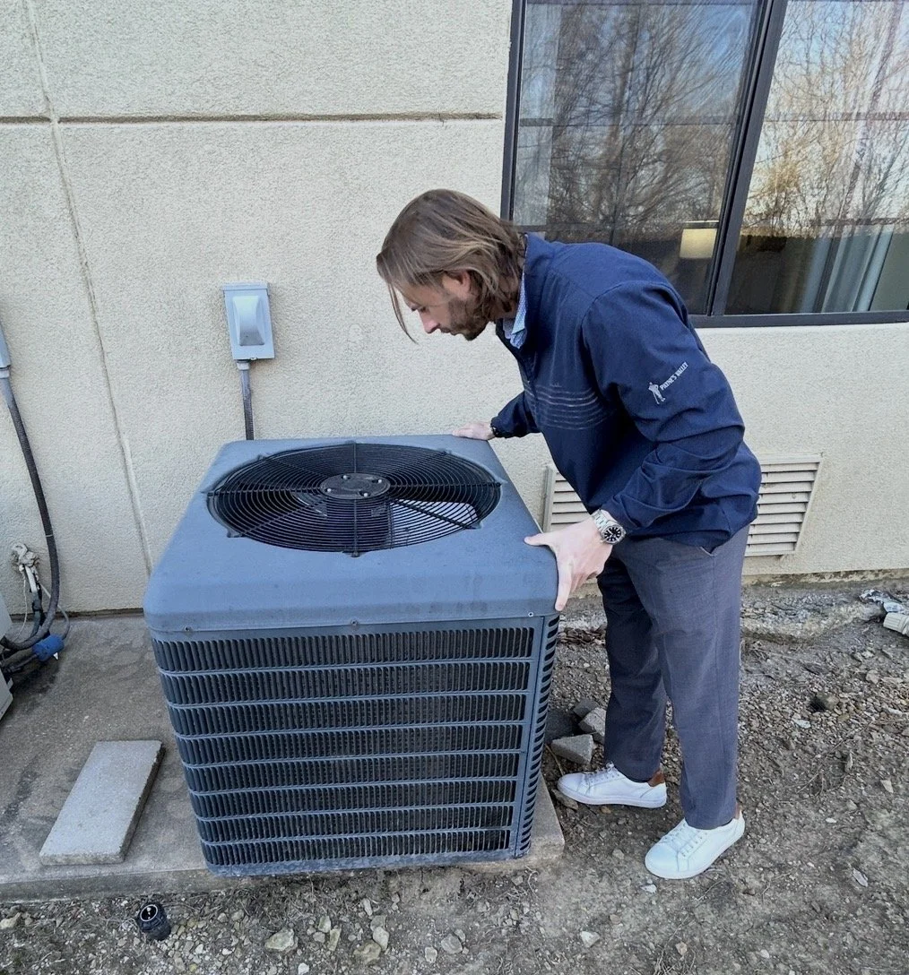 HVAC Maintenance technician checking AC unit.jpg