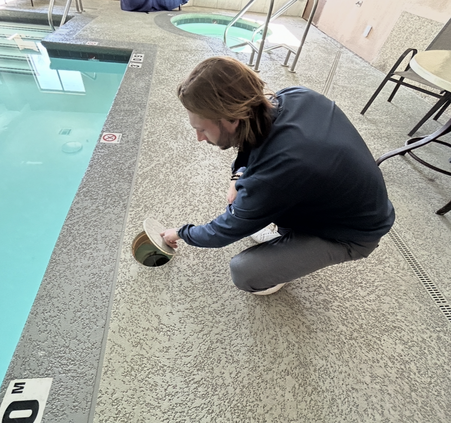 Pool technician testing hotel pool chemicals.png