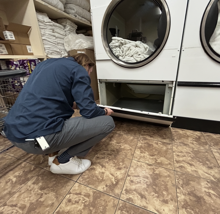 Technician inspecting commercial dryer vent.png