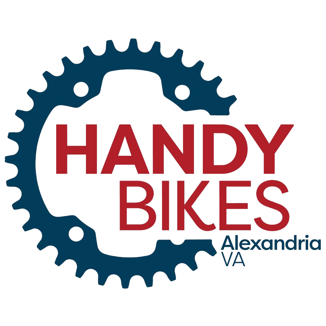 Logo for Handy Bikes in Alexandria, Virginia, featuring a large blue gear with the words 'HANDY BIKES' in red and 'Alexandria VA' in smaller blue letters.
