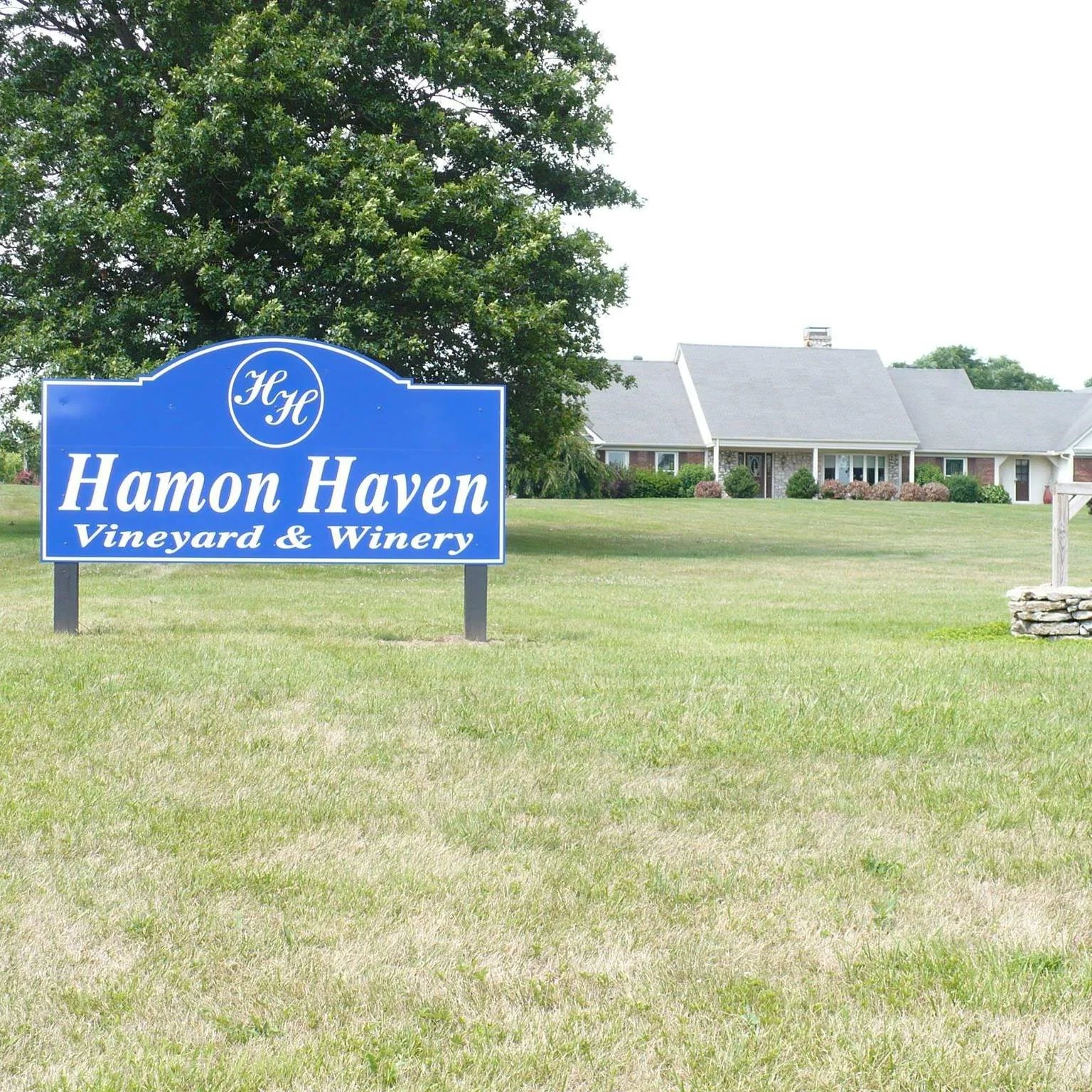 Logo of Winchester Clark County Farmers Market with farm elements, including a tractor, chicken, cow, and produce, and a water tower, emphasizing fresh and local products.