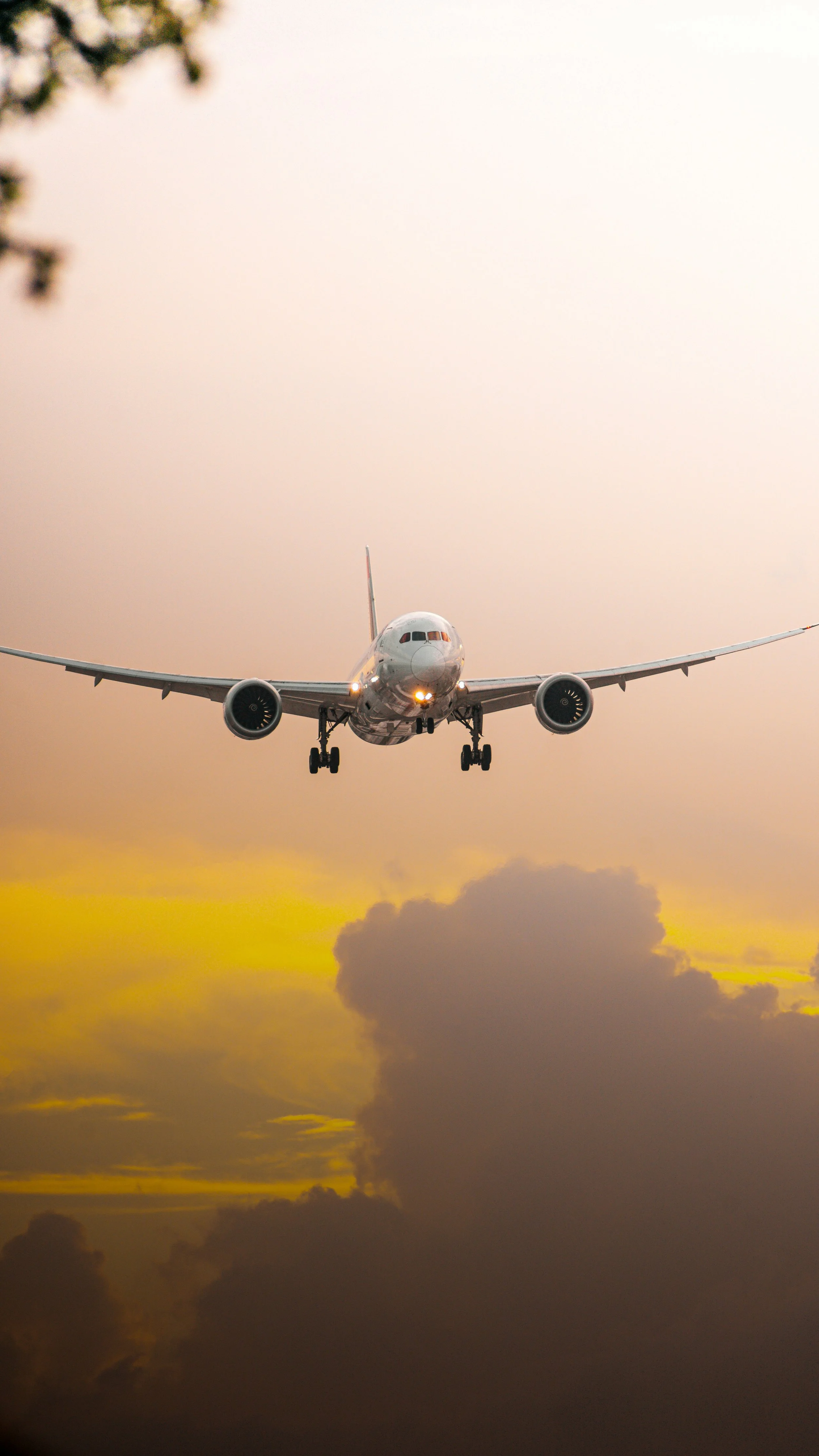 An airplane flying in the sky during sunset.