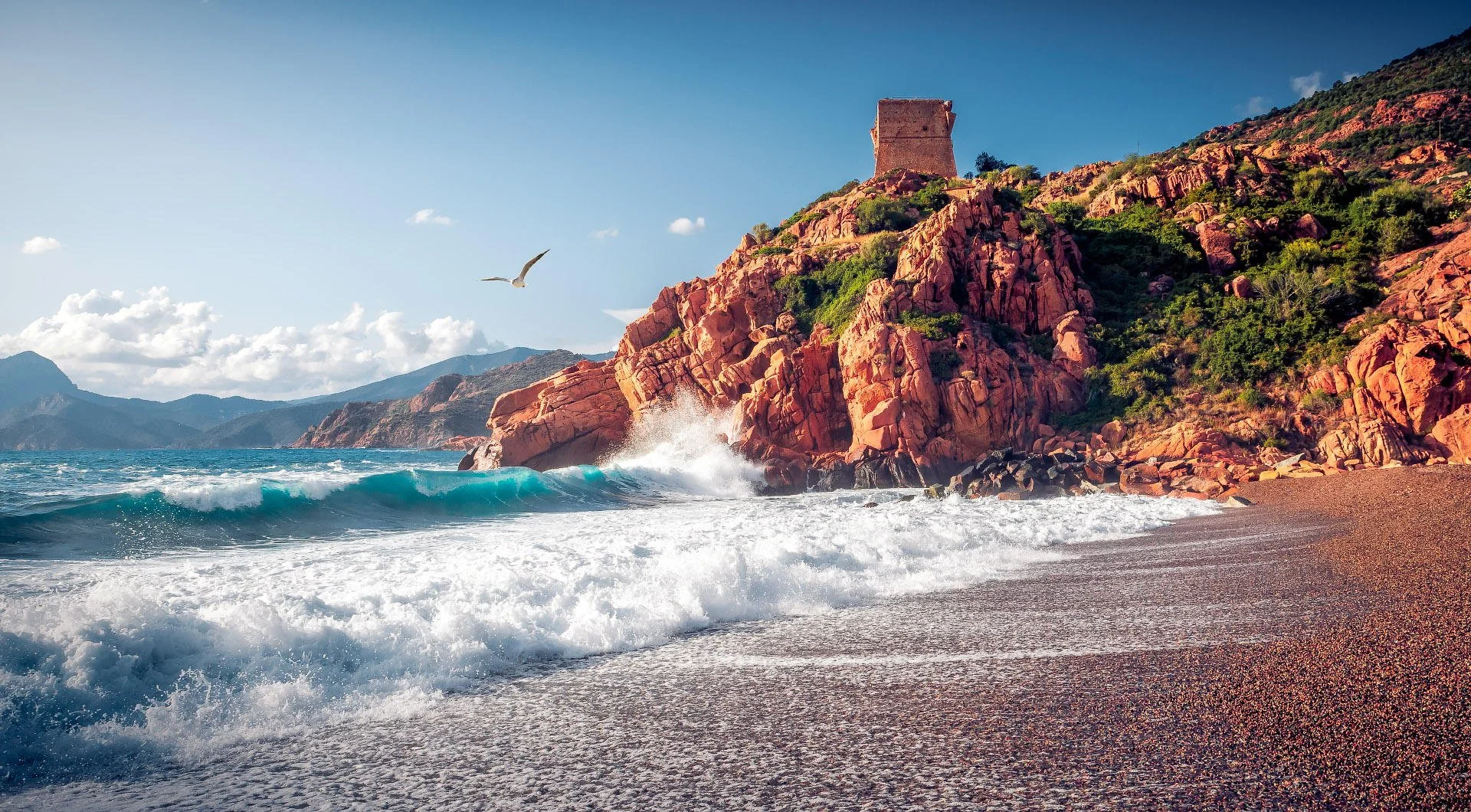 Coastal scene with rocky cliffs, a lighthouse on top, a seagull flying, waves crashing on the beach, and mountains in the background under a partly cloudy sky.