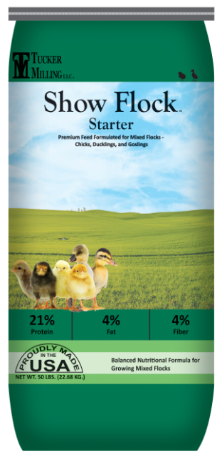 Packaging for Tucker Milling Show Flock Starter mixed flock feed, featuring a farm landscape background with six chicks and ducklings, and nutitional information about protein, fat, and fiber content.