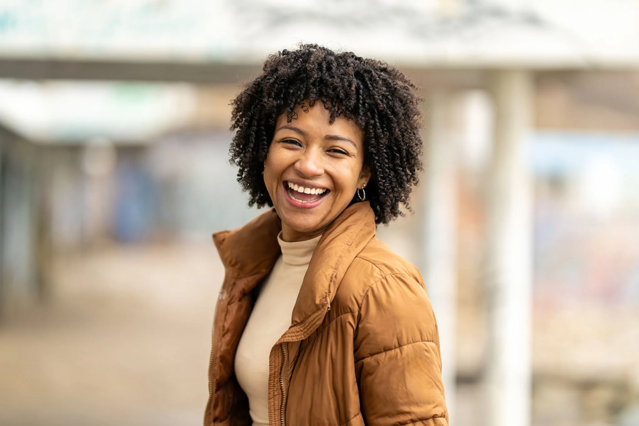 Patient smiling after a positive experience with compassionate women's healthcare