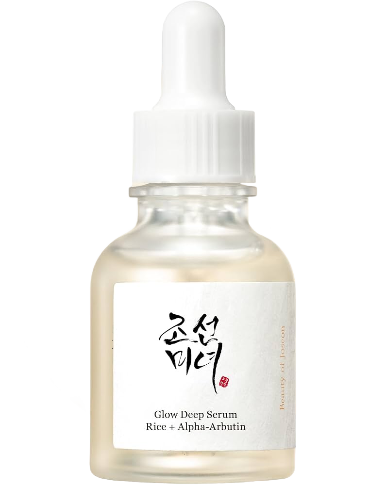 A small, clear glass bottle with a white dropper cap containing a serum. The label reads 'Glow Deep Serum Rice + Alpha-Arbutin' and has Korean characters above the English text.