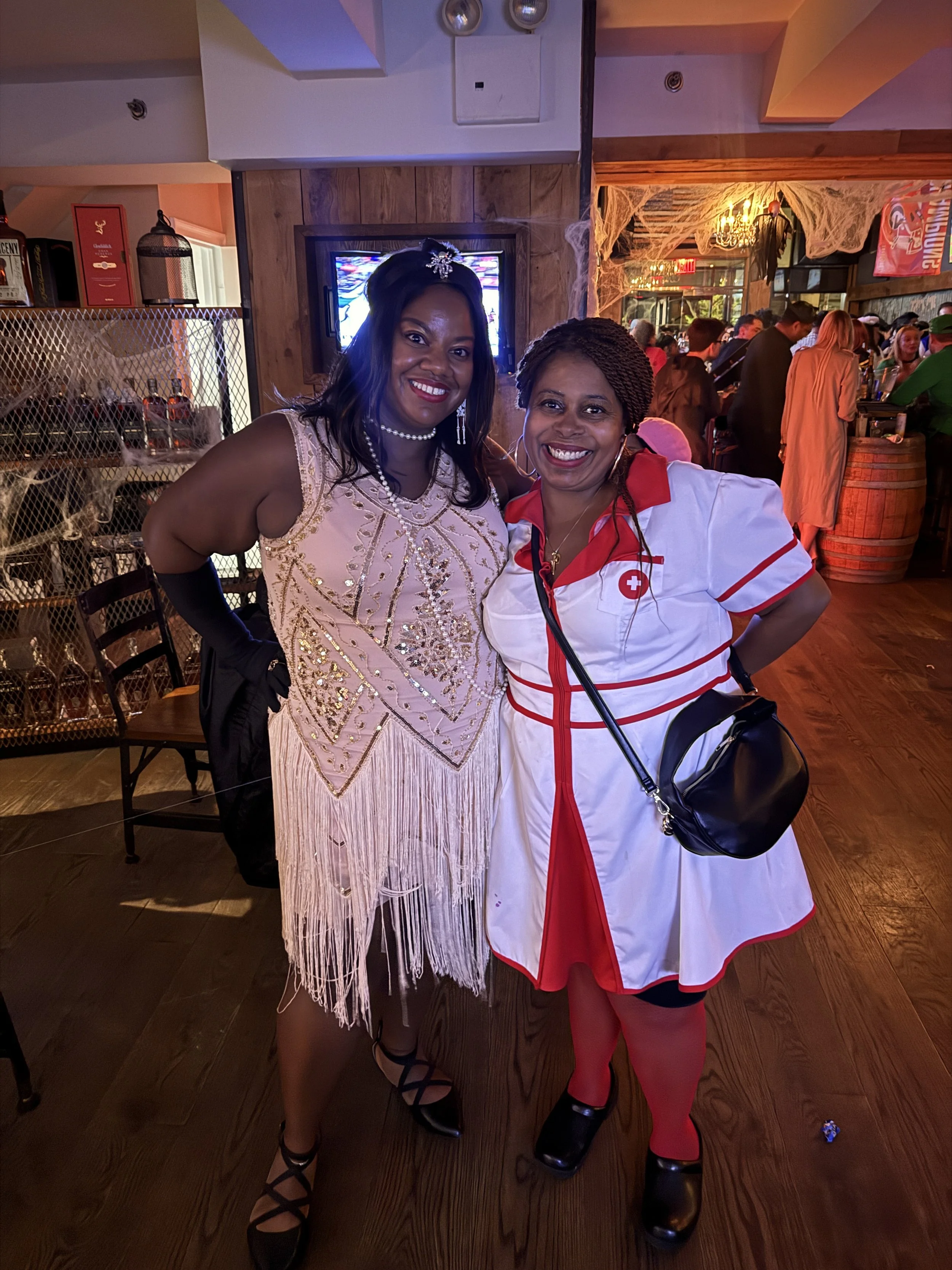 Lissette dressed as a flapper with a women dressed as nurse on halloween