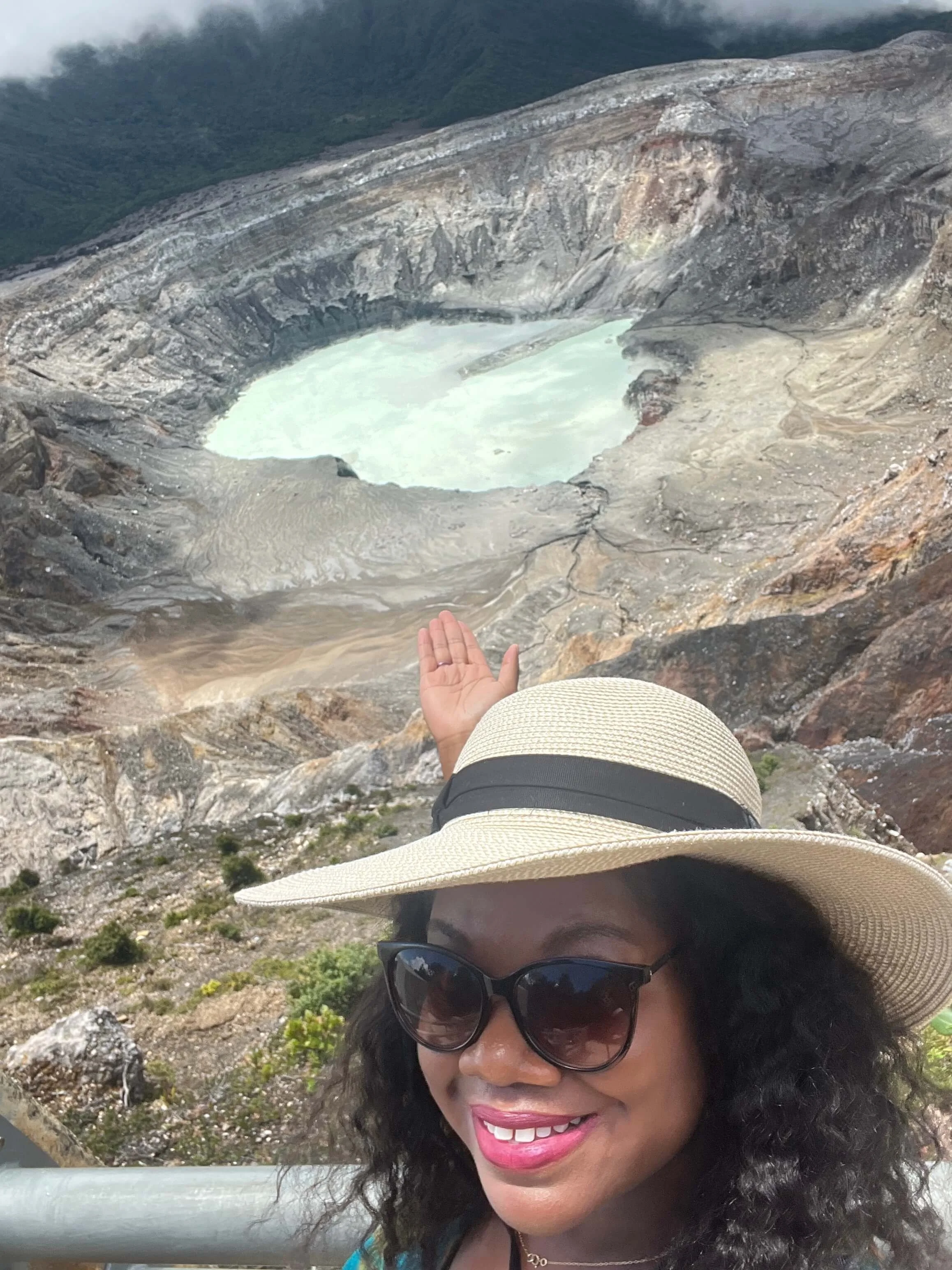 Lissette pointing at a heart shaper crater behind her