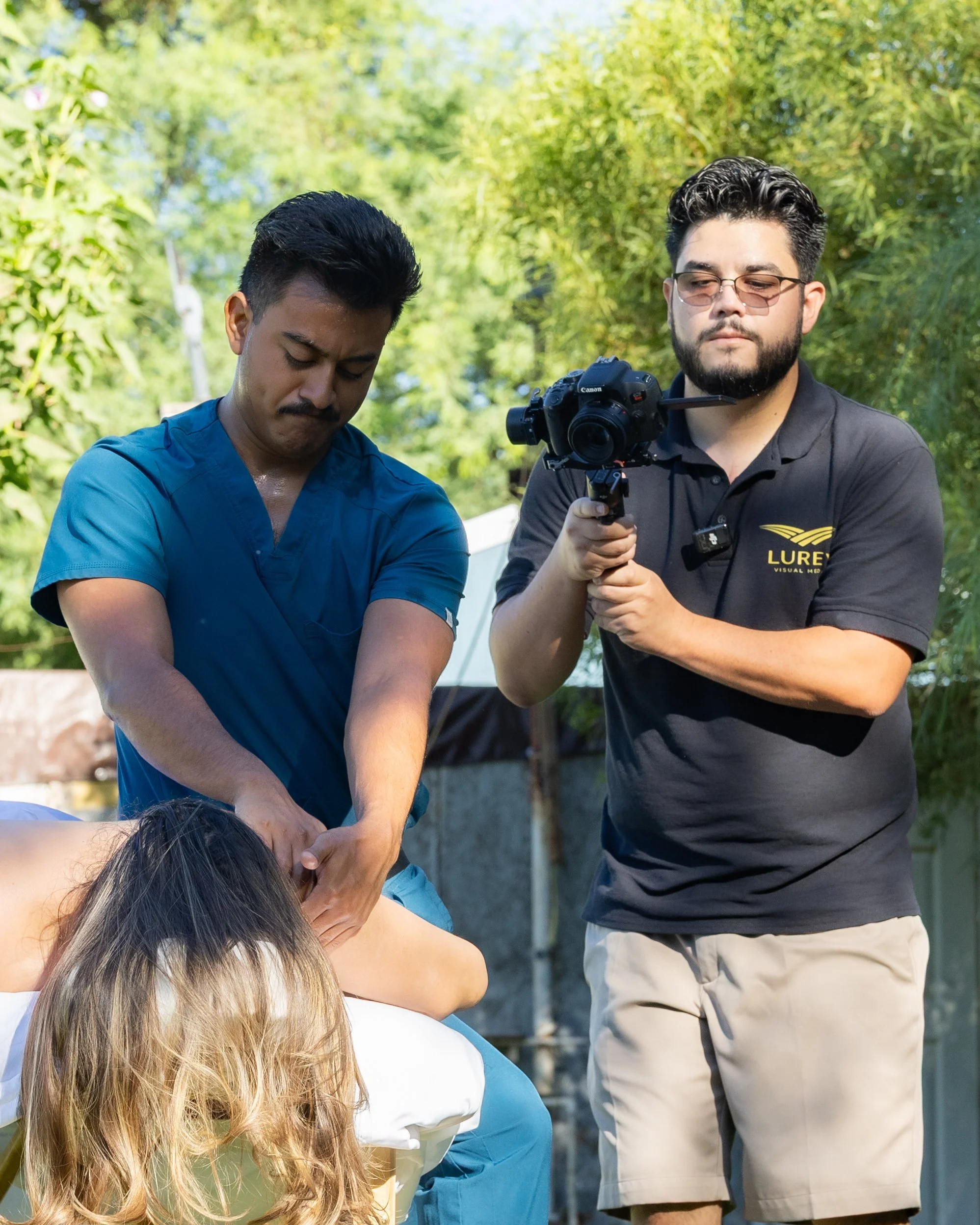 LuRey Visual Media videographer filming a massage therapist during an outdoor brand content session in Arizona.