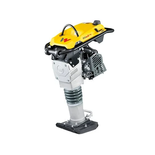A small, yellow, portable vibratory rammer used in construction for compacting soil.