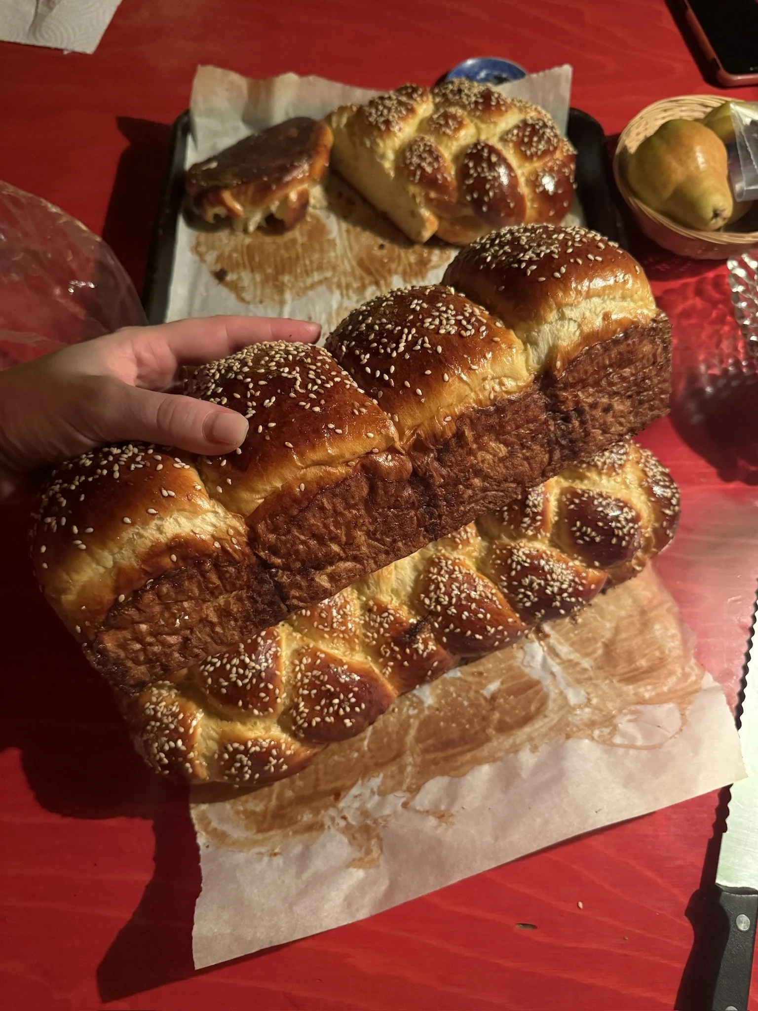 A Challah-dinner roll loaf, ready to be pulled apart and smeared with whipped butter.